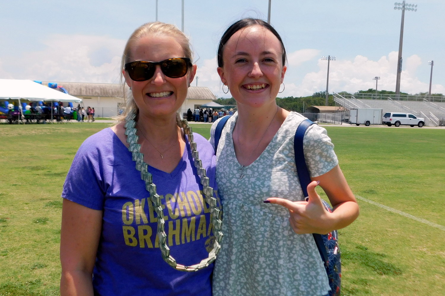 Amanda Riedel (left) with the money lei winner Madison Henry (right).